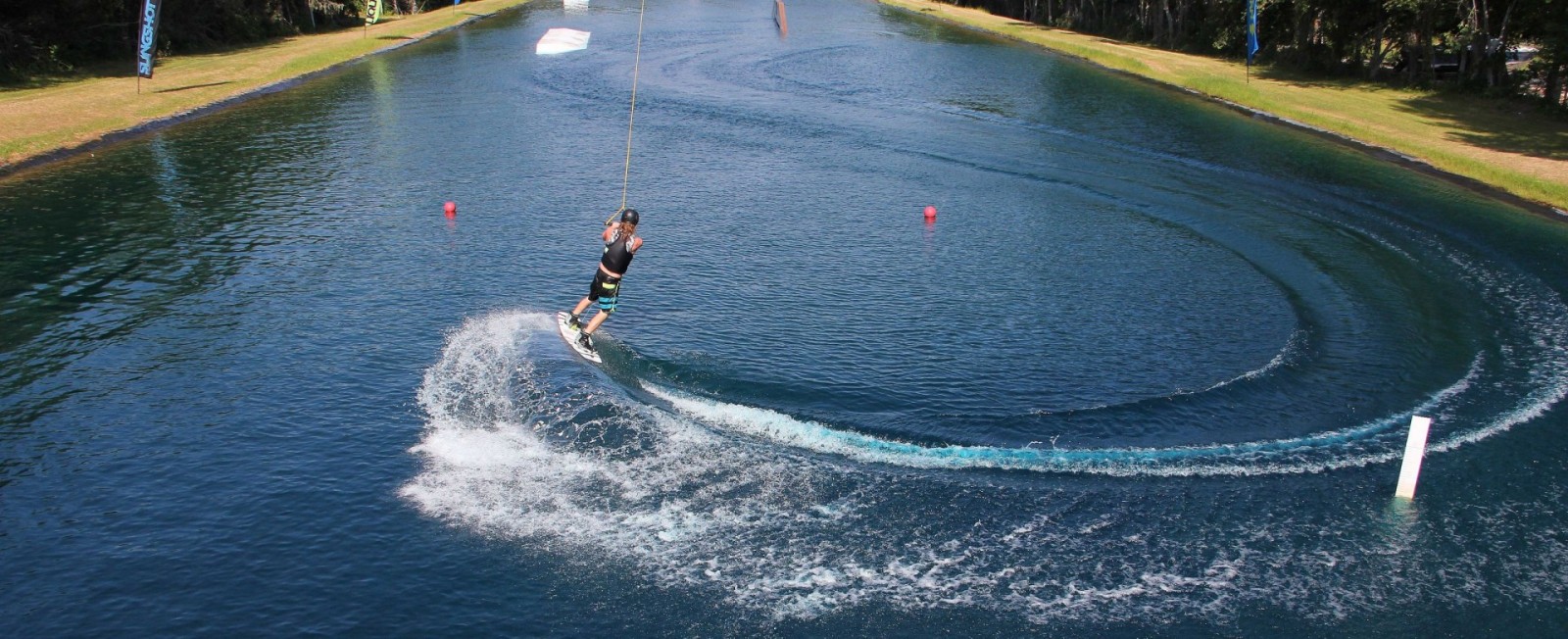 Zero Gravity two-tower portable wakeboard cable system panoramic view across a lake